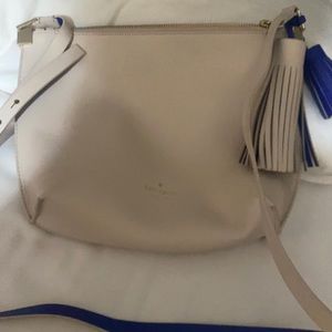 Kate spade tan crossbody with blue strap and tassels